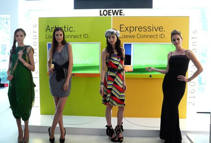 Loewe's Connect ID Smart TVs, fitted with Orange and Green fabric covers on the left and right respectively.