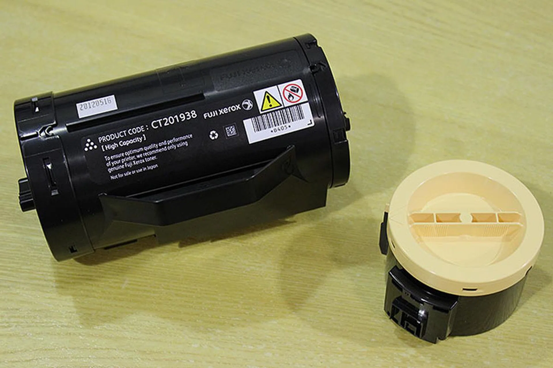 The toner cartridges used by the new printers are very small in size. On the left is the toner cartridge for the 355 series, on the right, the 255 series. If you print a lot, the 355 series has a high yield 10,000-page toner cartridge option. The toner cartridge for the 255 series lasts about 2,500 pages, and there's a twin pack option to drive printing costs down even further. The drum of the printers lasts about 100,000 pages.