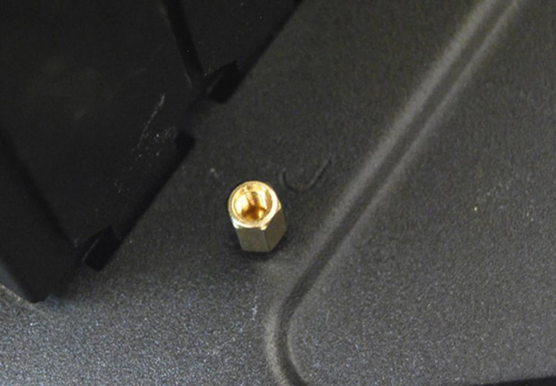 Motherboards have to be installed using traditional spacers and screws. Fortunately, the correct positions on the motherboard tray have been clearly labelled.