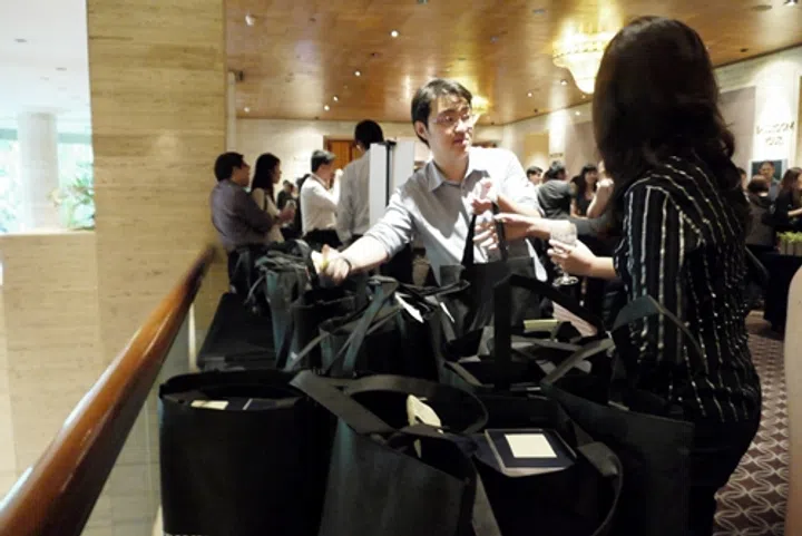 While others mingled and snacked, some were busy collecting their trophies at the collection point. Ray Ku, Assistant Manager for Circulations Department, SPH Magazines, seen here assisting with the process. Some lucky winners walked away with more than one.