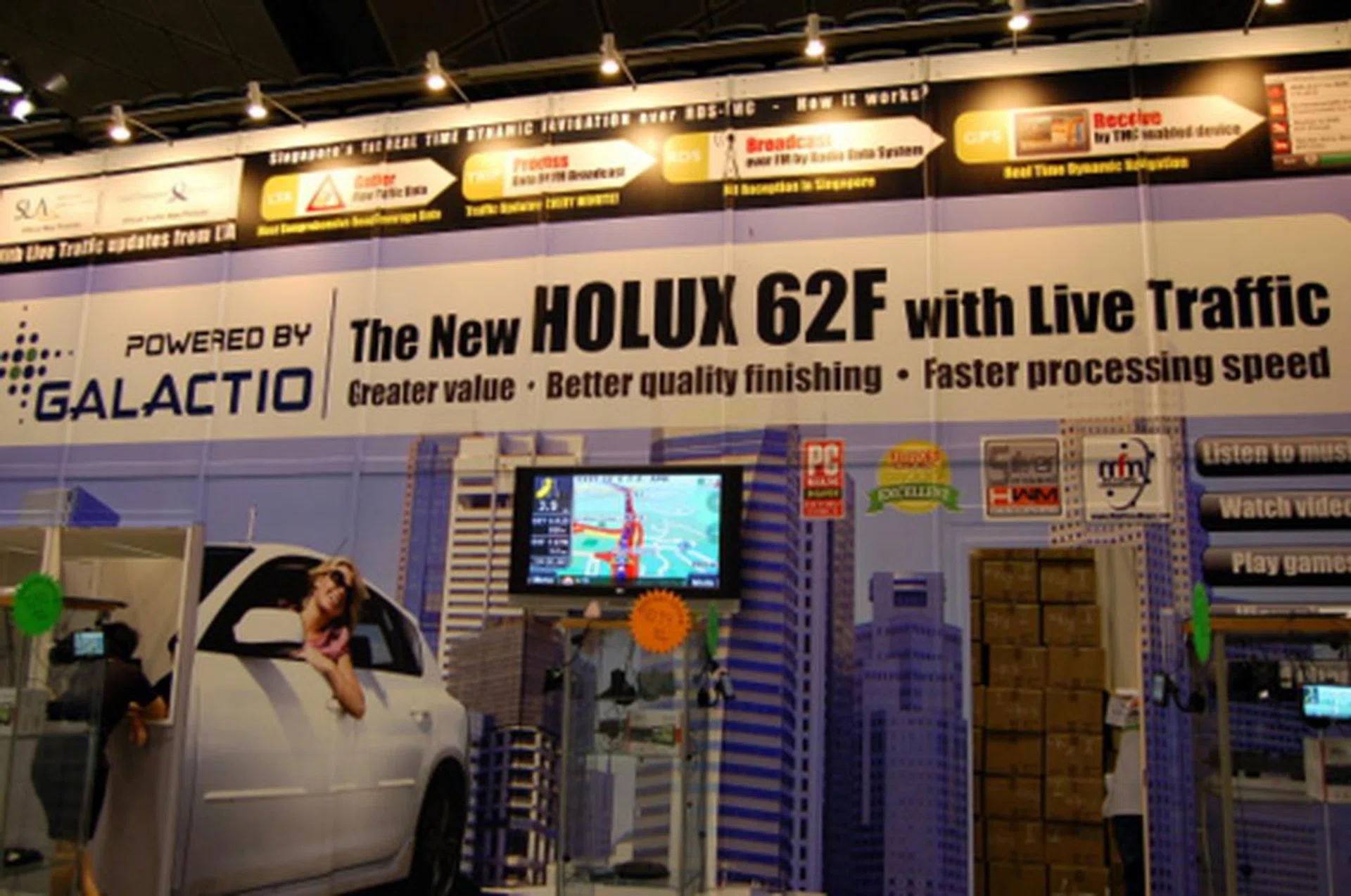 The star of Eastgear's show is the new Holux GPSmile 62F. This 5-inch model comes with Galactio PAPAGO! X3 software that allows traffic updates to be downloaded in real-time. How does this happen, you ask? Not with a SIM card, but through RDS-TMC, the same system by which you see your station name in your car radio. The 62F is powered by the latest SiRF Atlas IV chipset.