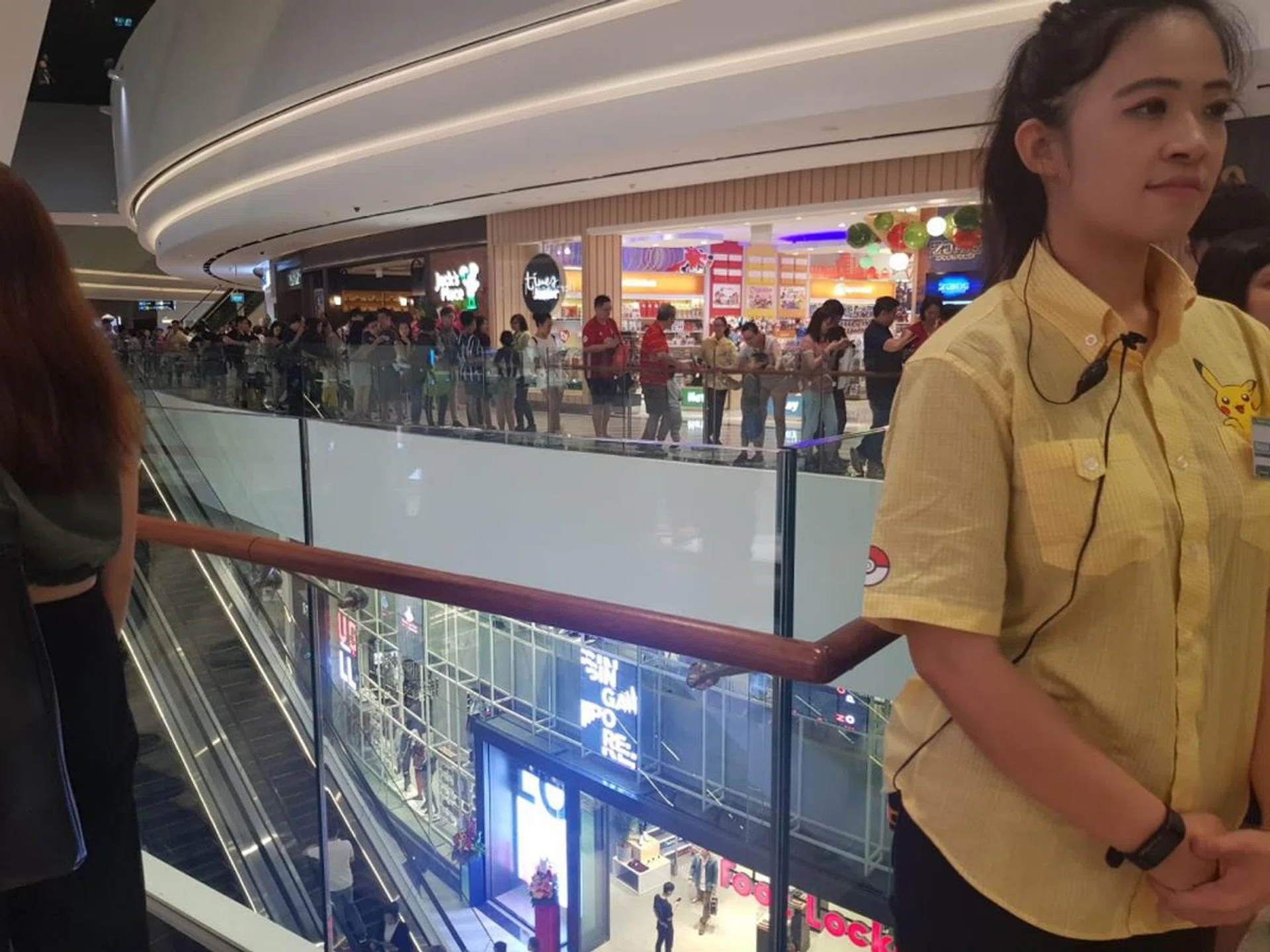  A Pokémon staff helping to manage the queue.