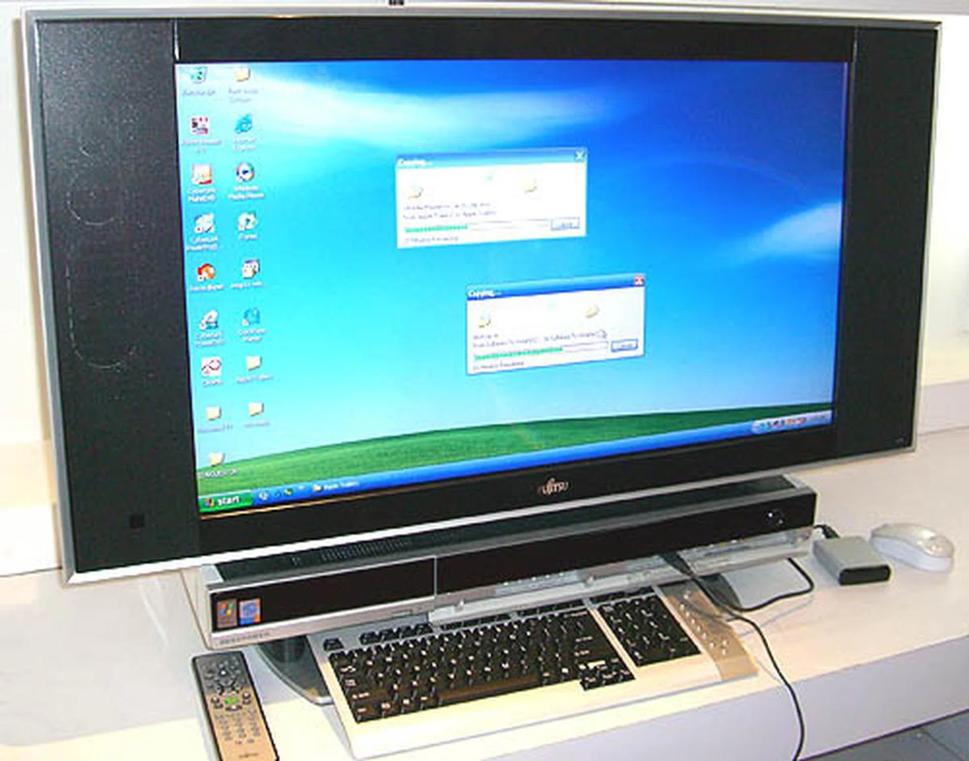 Fujitsu's idea of a home entertainment PC is big. Very big. The Deskpower TX costs S$4,888 but for that price, you'll get a 32-inch widescreen LCD display. You may even overlook the PC portion, which is integrated flawlessly into the unit and runs Windows XP Media Center Edition 2005.