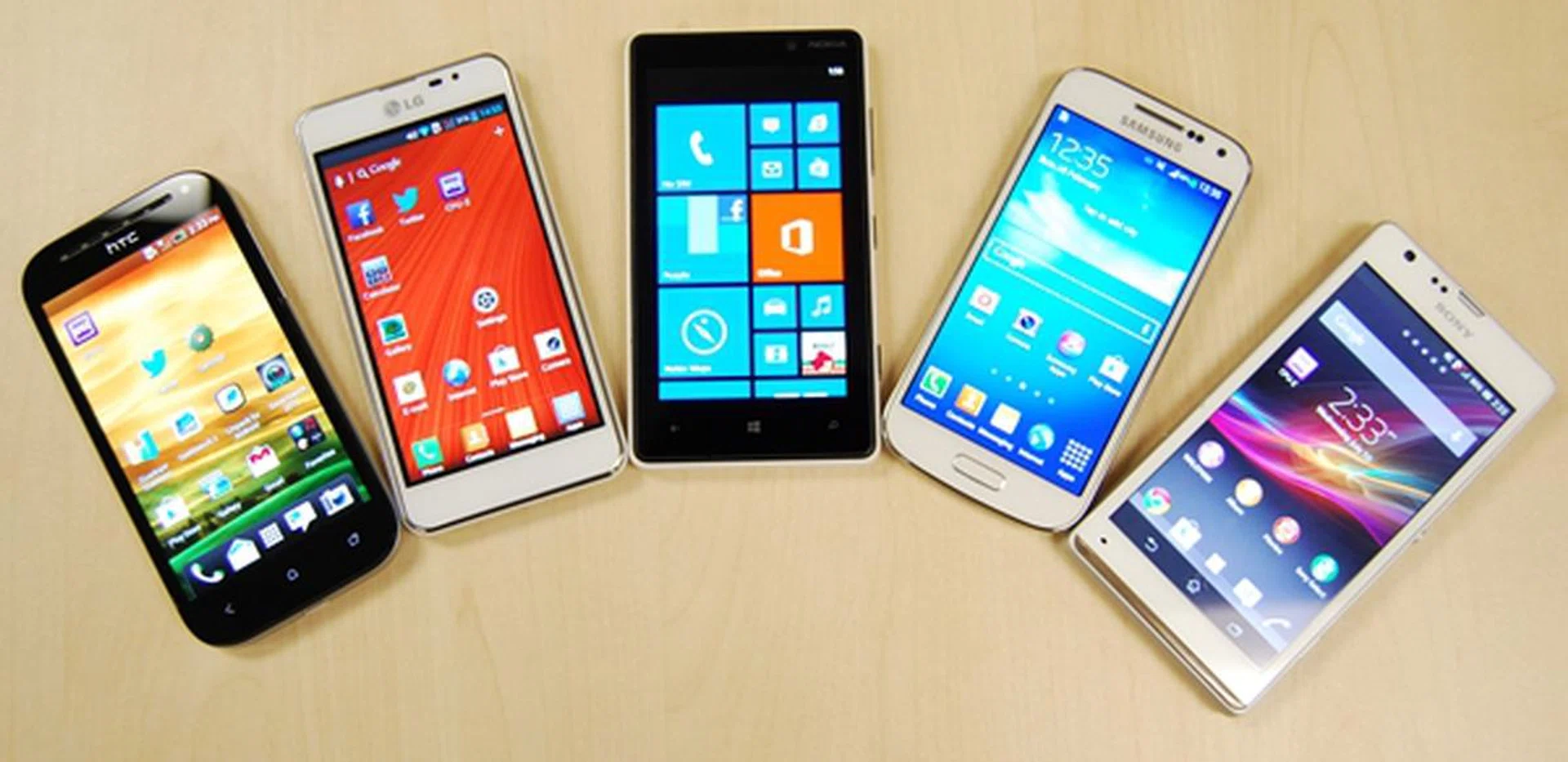 The front-facing shot of the five phones. <br> From left to right: HTC One SV, LG Optimus F5, Nokia Lumia 820, Samsung Galaxy S4 mini, Sony Xperia SP.