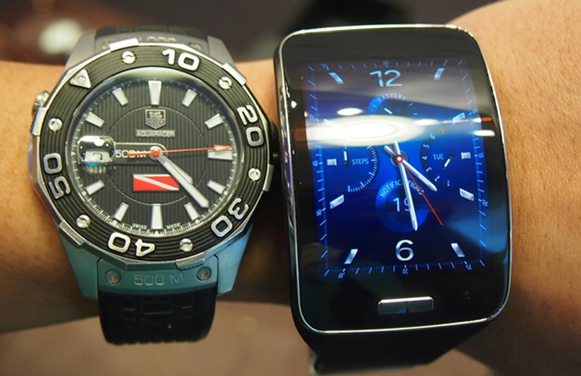 The Samsung Gear S seen beside a conventional watch.
