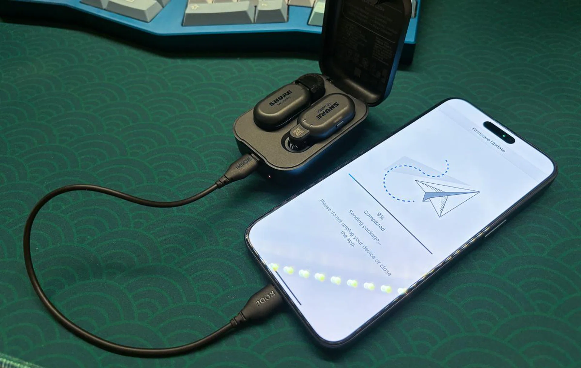 Charging case plugged into a phone and updating.