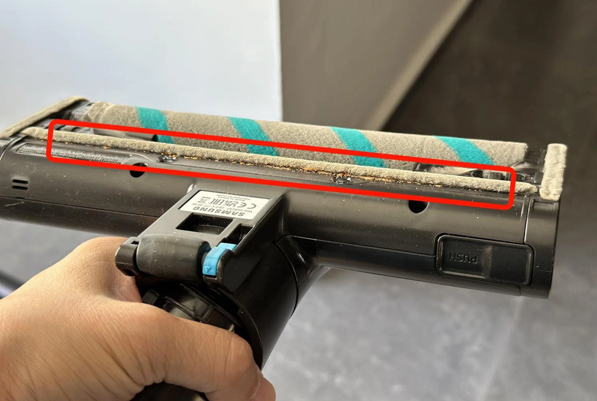 The brush strip probably helps maintain suction forward, but if you move the brush head backwards, dirt can get pushed back and stuck behind the brush without being sucked into the vacuum.