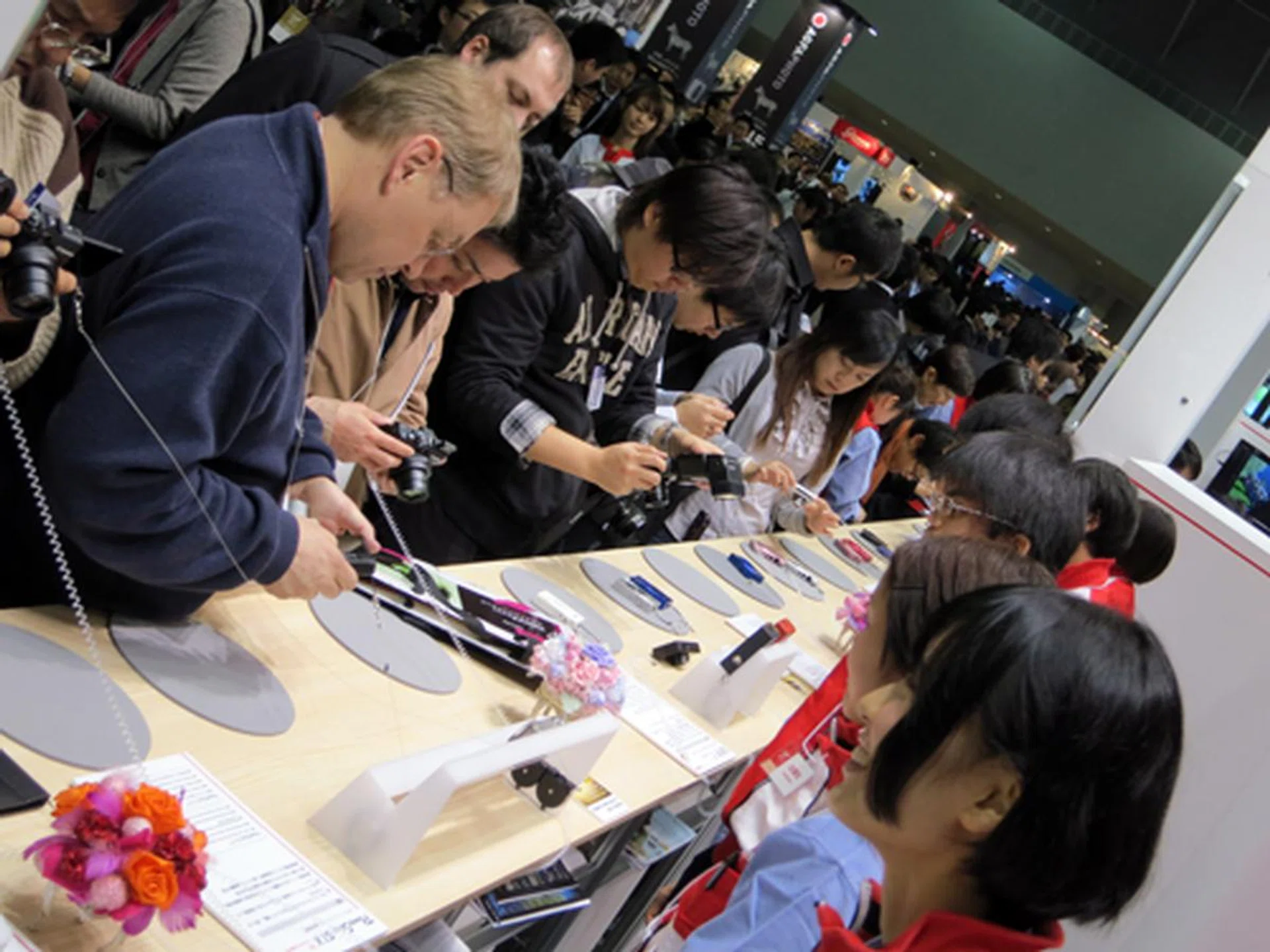 Here’s a peek over Canon’s compact camera area, where crowds gathered to try out the new digital compacts that we’ve just discussed earlier. If you’ll notice the smile on the face of the girl in the foreground, you’ll see that the Canon staff were more than eager to assist the curious onlookers.
