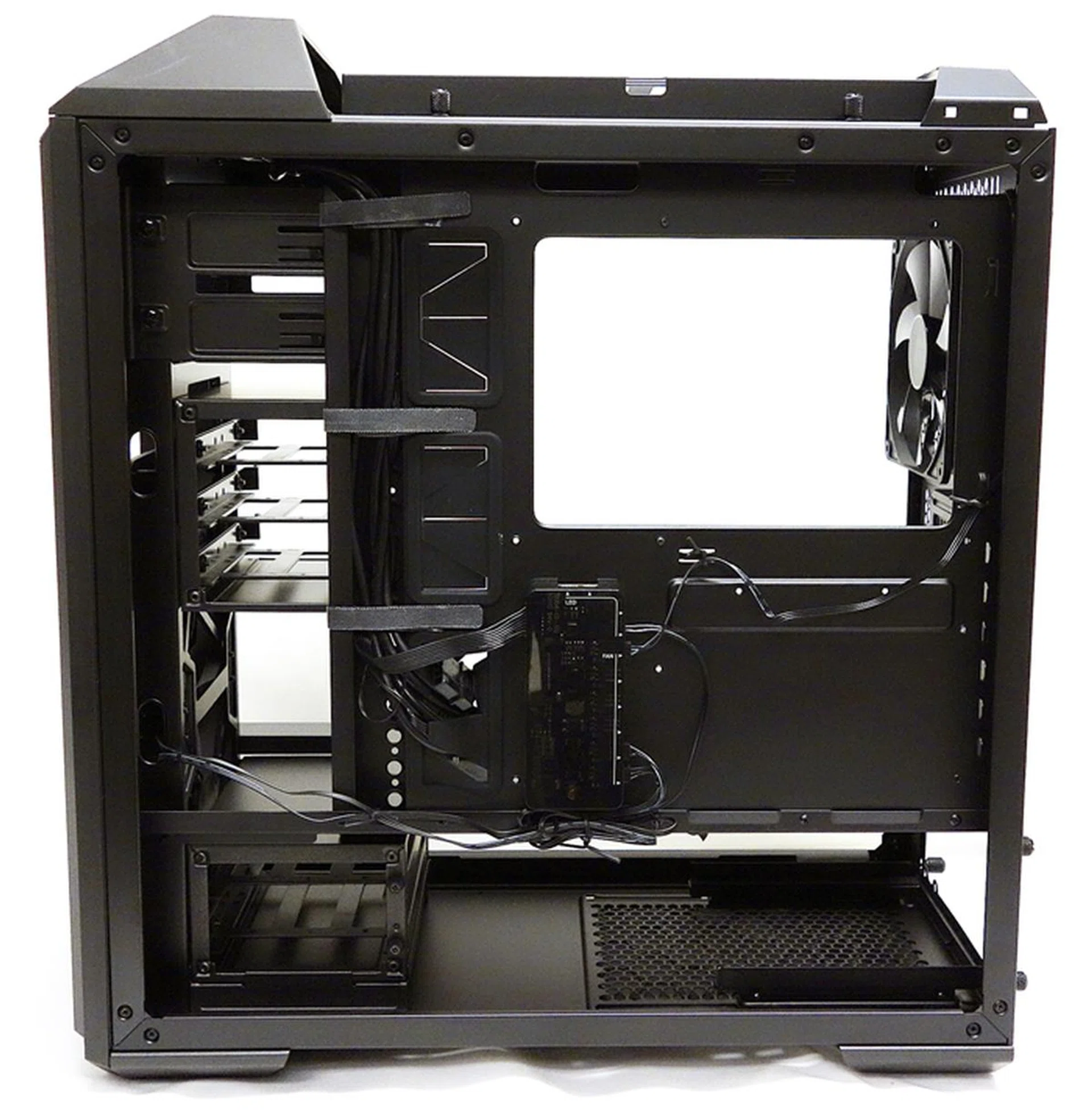 With the panel removed, we see the cable management system, and its velcro straps that keep things in order. We also see the fan and LED controller hub just below the CPU cooler cut-out.