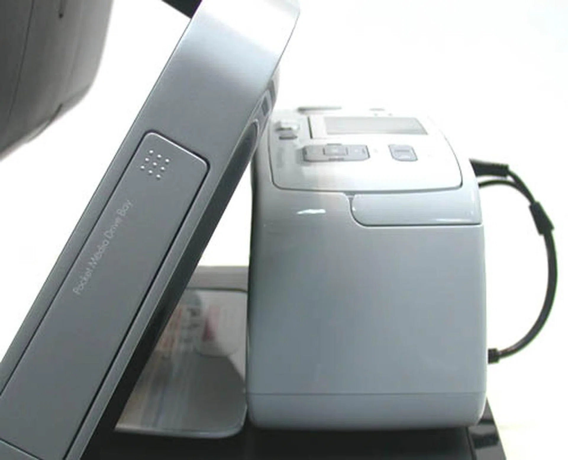 This being HP, one would expect printers to play its part. For the TouchSmart, the space at the back has been utilized for a printer dock. Compact HP photo printers like the HP Photosmart A616 (sold separately) fits snugly into the intended printer station. There are even depressions on the surface that match the feet of the printer exactly. A special cable that marries the power and USB cables together is used to connect the printer to the TouchSmart PC, so that the printer is drawing power via the PC and ensuring that you won't find a nest of cables at the back. Also, the Pocket Media Drive bay can be seen at the side, where one can slot in a 80, 160 or even 300GB portable HP Pocket Media Drive to expand hard drive capacity or just to transfer files.