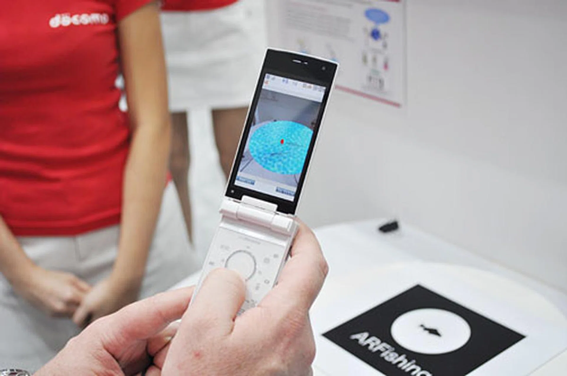 Fishing on our augmented reality phone! The ARFishing sign turns into a pond on the screen of the phone.