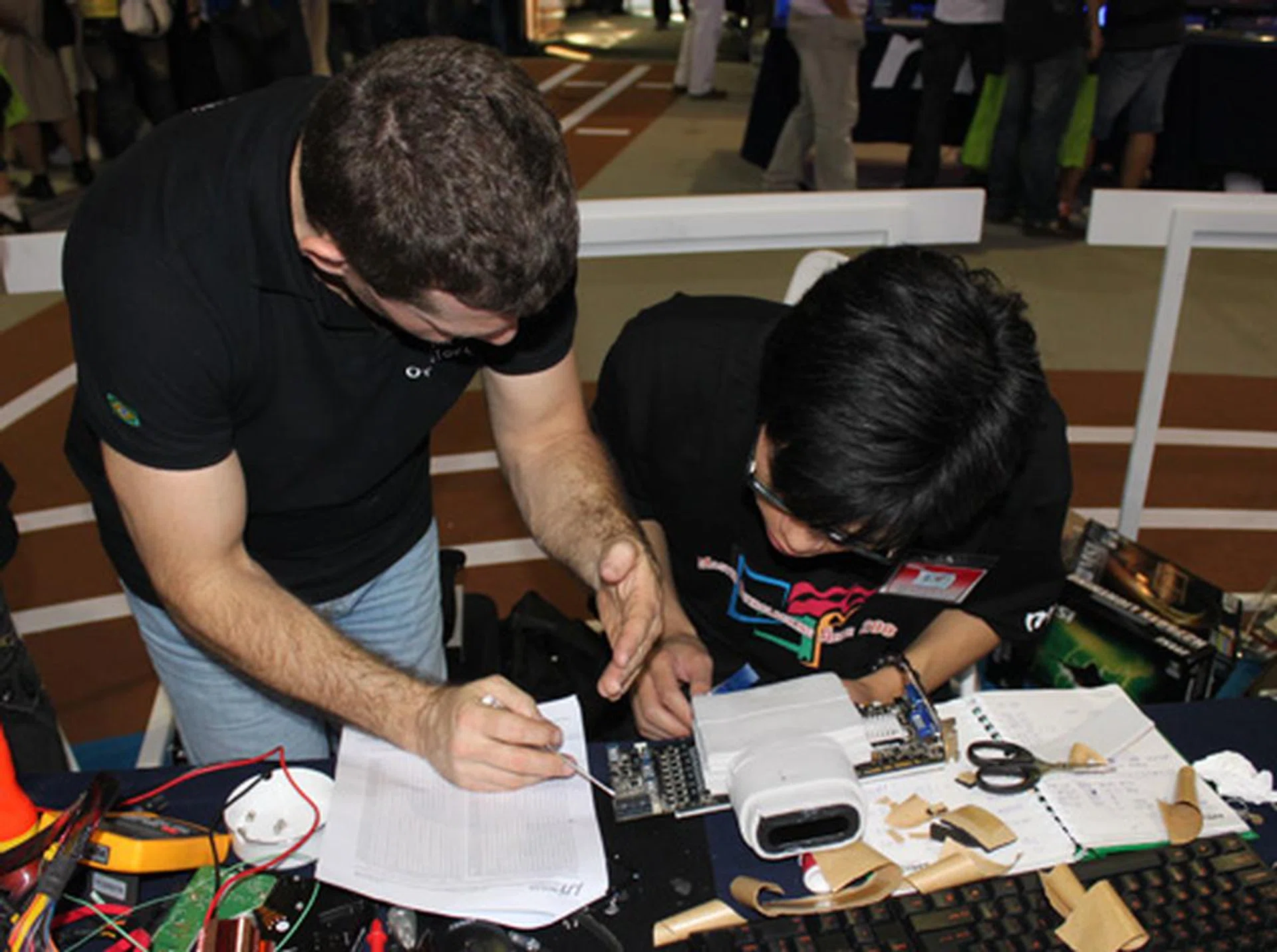 Despite it being a competition, there's evidently genuine camaraderie amongst overclockers as Ronaldo from Team Brazil helps Team China 1 mod their graphics card.