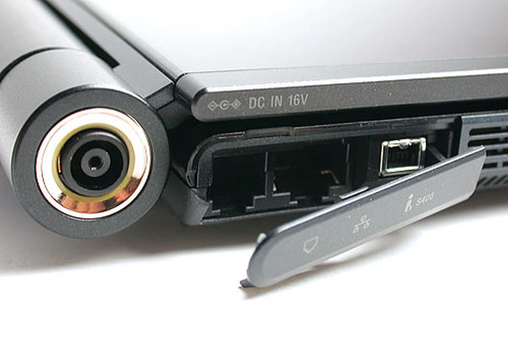 Some of the less oft used ports are concealed, like the mini FireWire and phone modem jack. The connector to recharge the battery is also integrated into the cylindrical spine of the notebook like the power button.