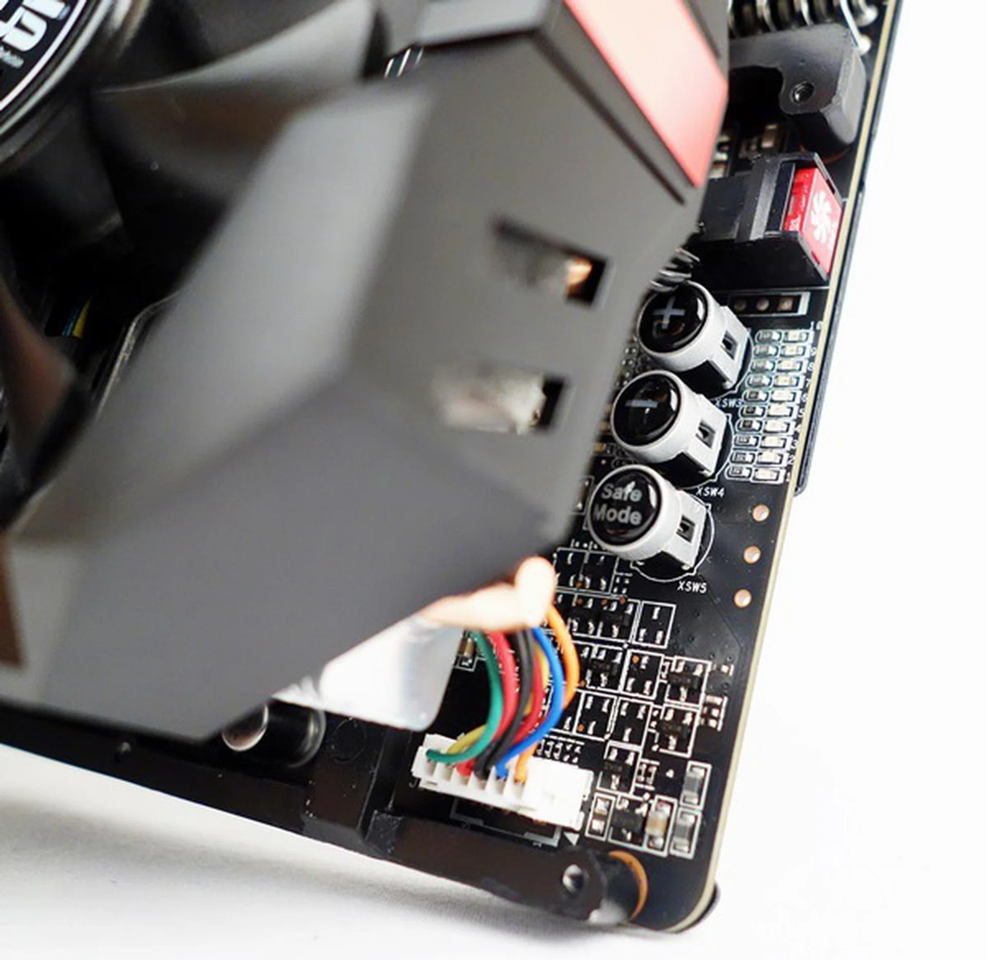 The TweakIt buttons that consist of the "+" and "-" onboard ones. They allow the user to tweak the voltage of the GPU core. We can also see the Safe Mode and the Turbo Fan Activator buttons.
