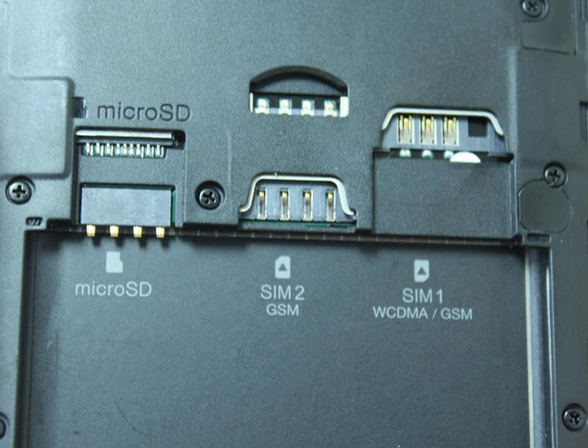 From left to right: microSD memory card slot, micro-SIM card slot and regular-sized SIM card slot. Only SIM slot 1 supports 3G data connectivity; slot 2 only supports 2G data connection.