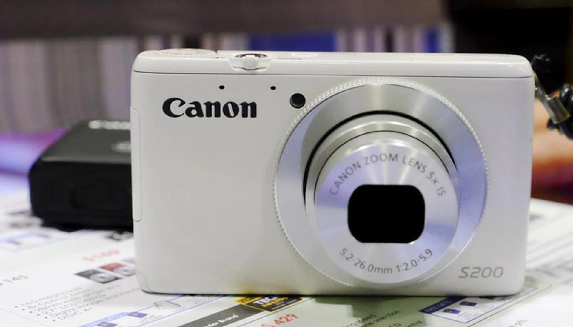 The S200 is a 10.1MP compact camera with 5x optical zoom for $299. The additional 2-year warranty costs $70, but comes with a Tokidoki bag instead. Freebies here are an 8GB SD card, a 16 GB SD card, case, and selfie pod.