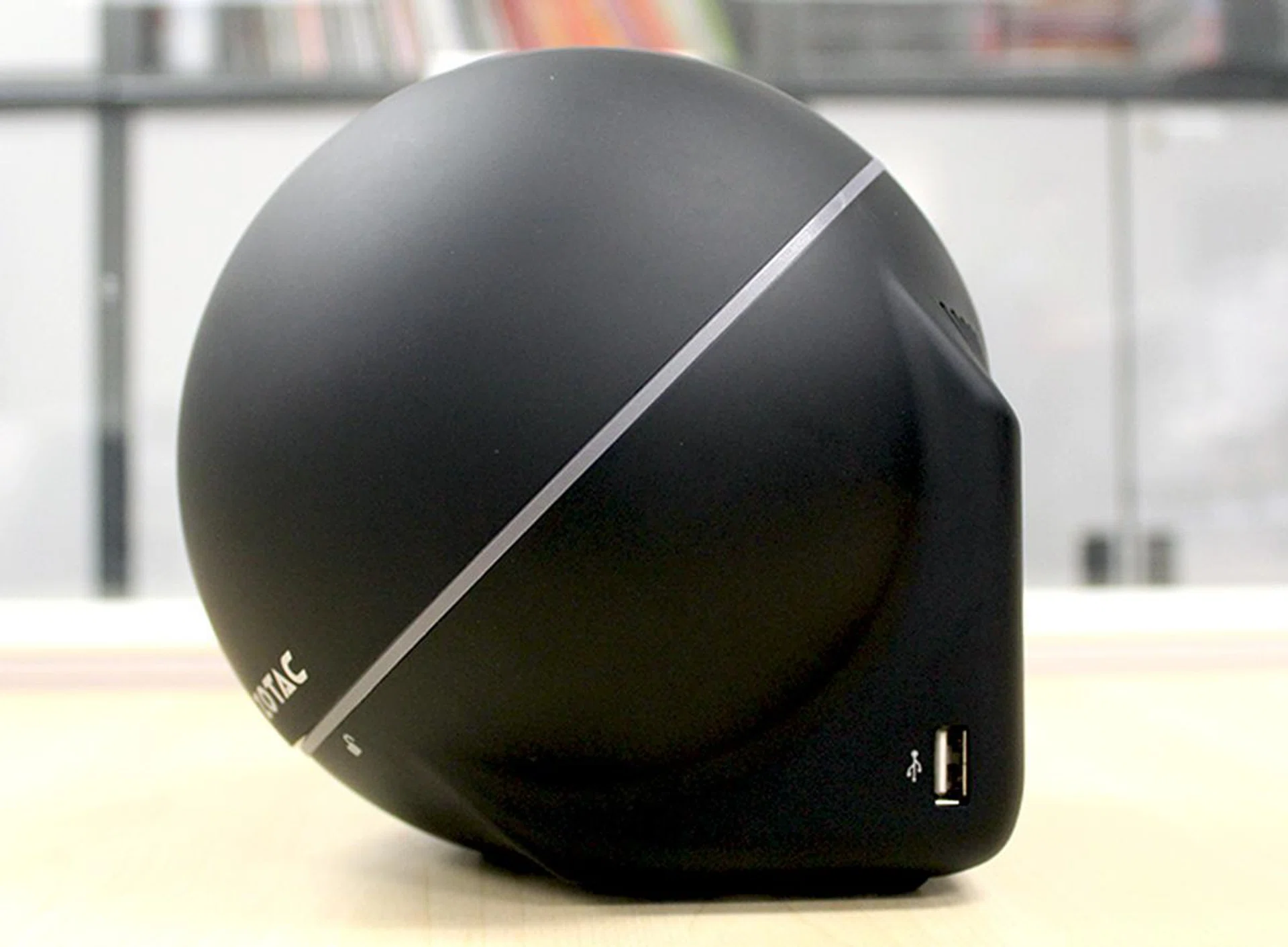 The base is actually square-shaped to help the Zotac ZBOX Sphere OI520 stand on its own. Note the additional USB 2.0 port.