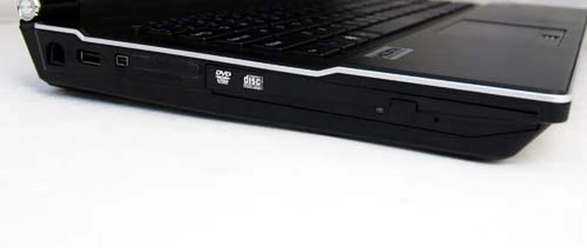 As for the left, you'll find a hole for an old school modem jack (the unit has no modem), another USB port, an IEEE 1394 port, SD card reader and an optical drive.