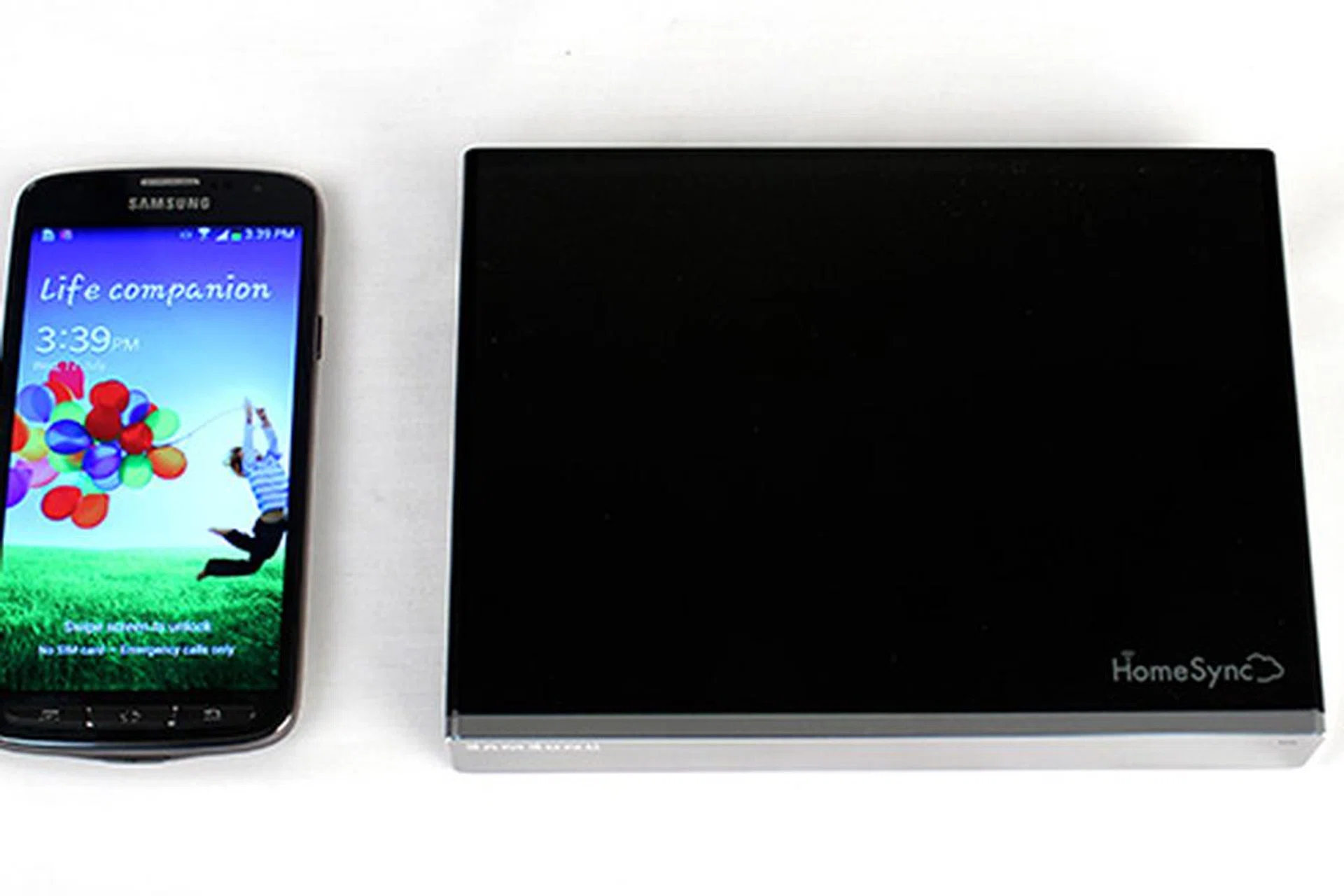 The HomeSync device is actually really compact. Here it is next to the new Galaxy S4 Active.
