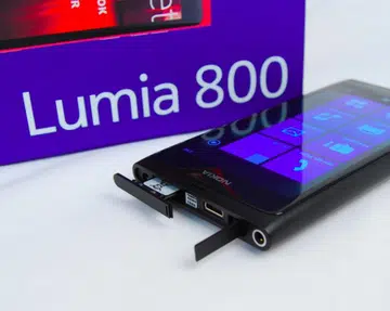 The Lumia 800 takes a cue from Nokia's MeeGo-based N9, right down to the microUSB port with its hinged cover, and a spring-loaded micro SIM card holder.