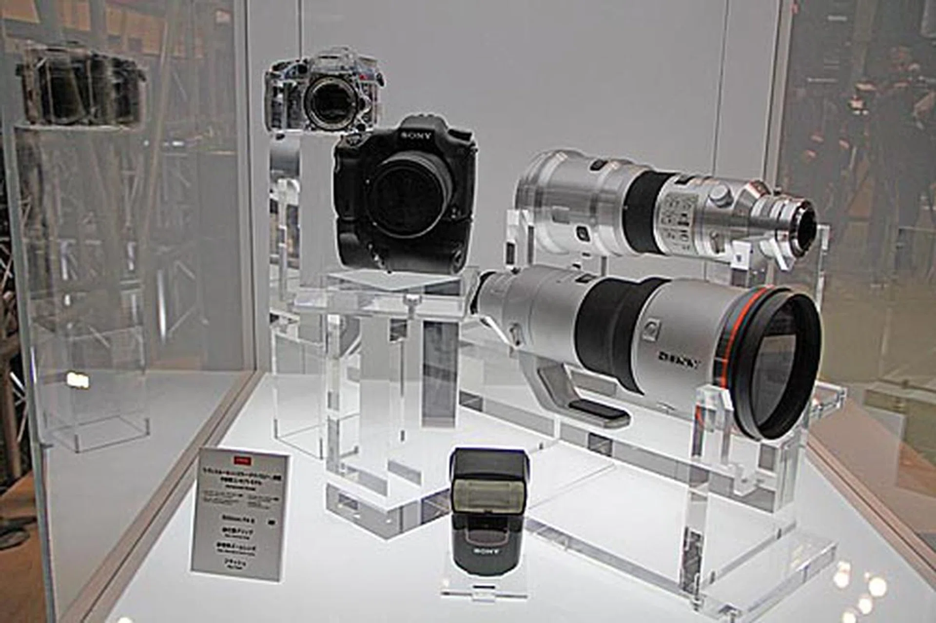 Mockups of Sony's new advanced Alpha model based on the company's Translucent Mirror Technology that's to be launched in 2011 (it also uses an APS HD CMOS sensor, and records Full HD movie in AVCHD format), a new vertical grip, a new standard zoom lens, a new flash, and a new 500 mm F4 G lens.