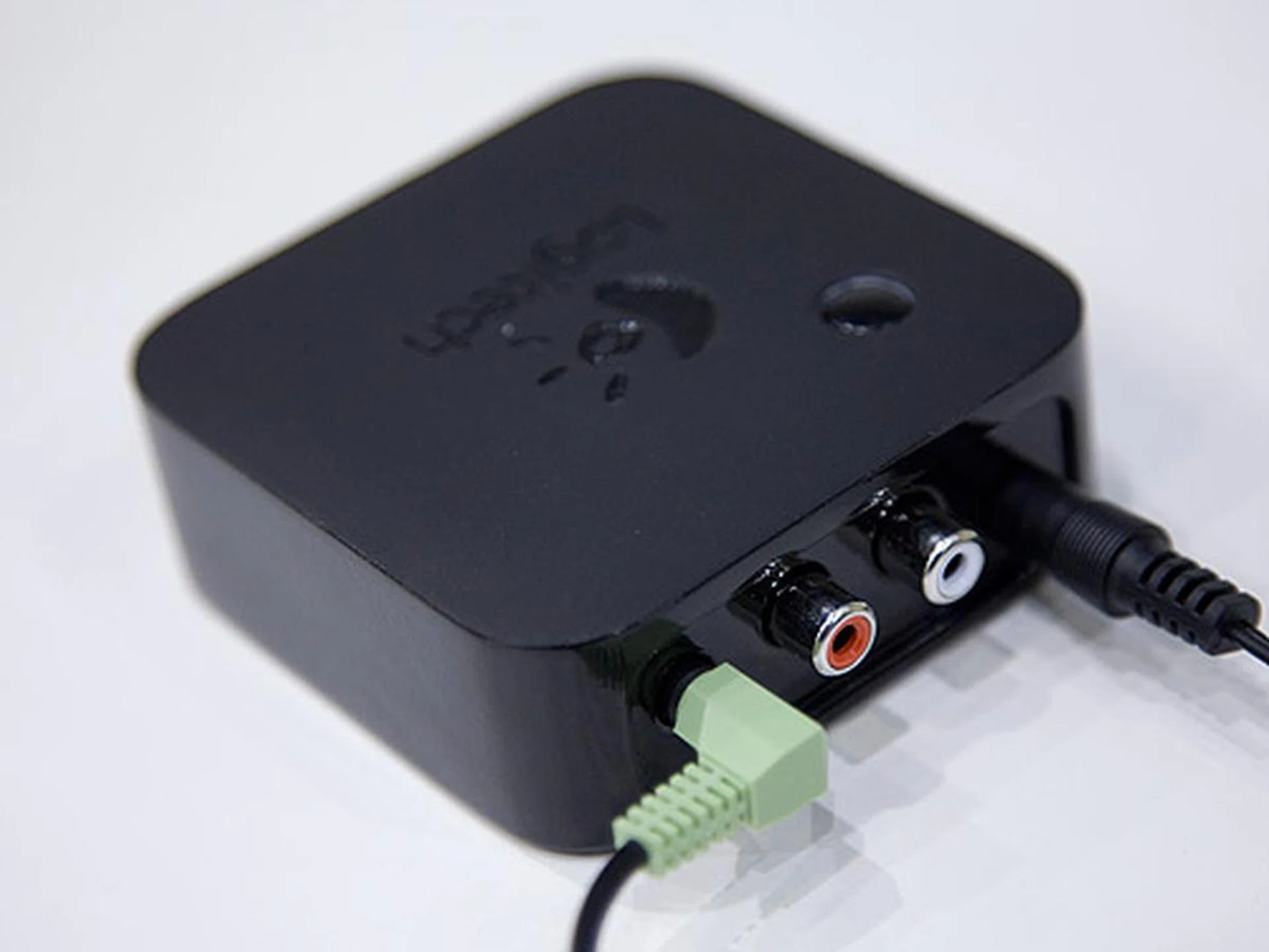 Rear view of the Logitech WiDi adapter. It can output directly to speakers via a 3.5mm stereo jack or phono jacks.