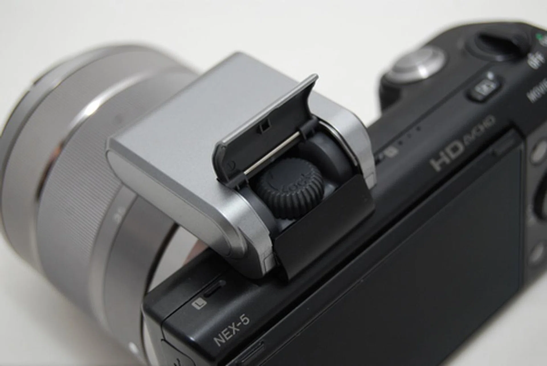 The flash attachment secures through the back.