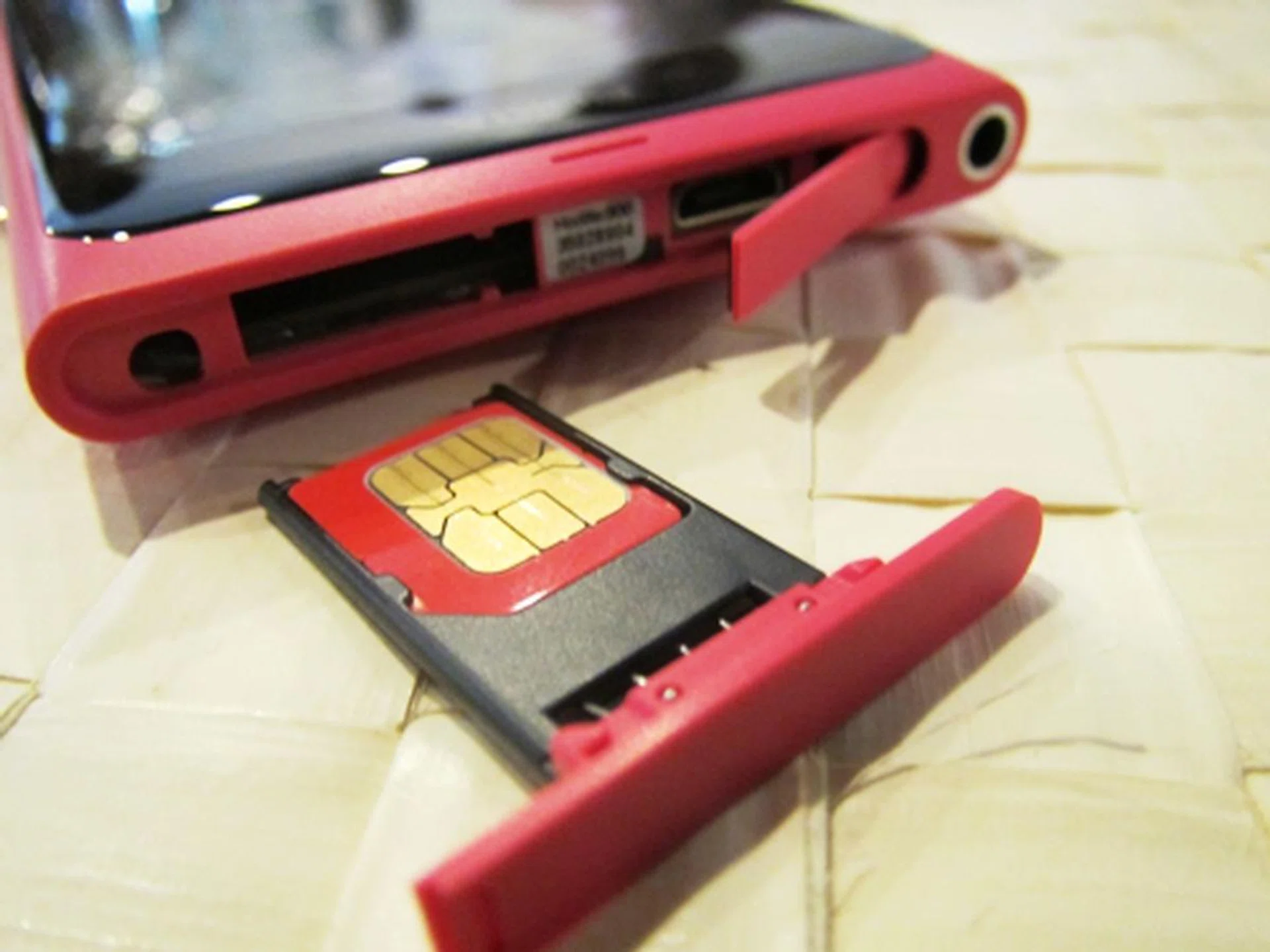 Like the N9, the Lumia 800 comes with a micro SIM (yes, you read it right) card holder. Along with a microUSB port, these two elements are well-tucked under a hinged cover and spring holder that are located on the top of the phone.