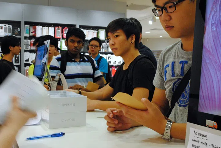 Buyers lining the iStudio service counter in Paragon as they wait for the latest iPhone models.