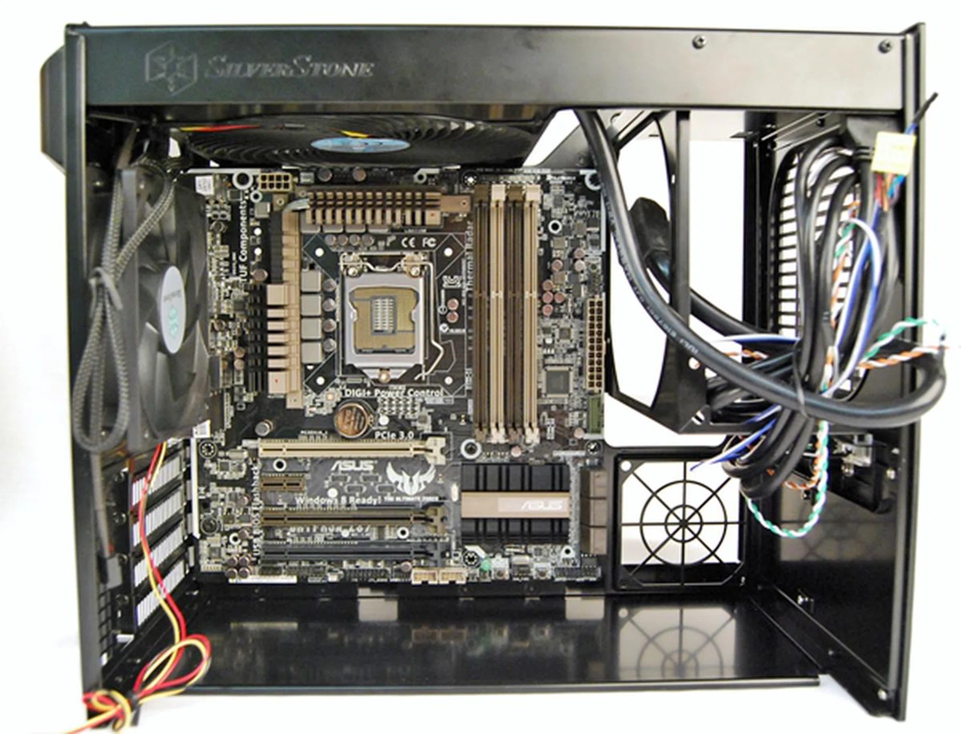 Here we have the latest mATX board from the ASUS - the Gryphon Z87. Notice the extra tight fit as just after the board ends, you can see it meets the PSU holder and the optional exhaust fan below it. So yes, the case can take in a mATX board natively, but be ready to wrestle with some cables.