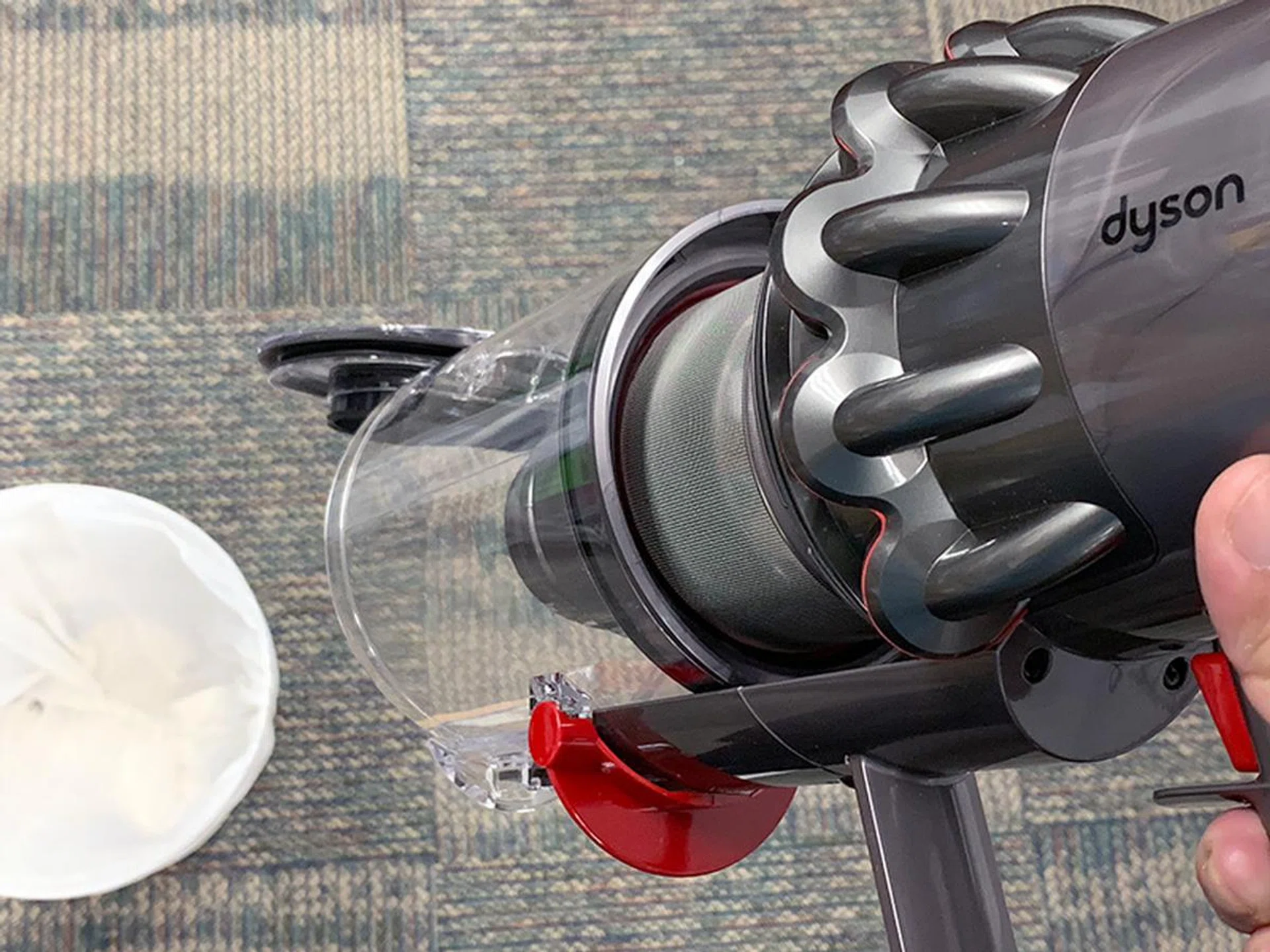 Like the V10, you point the V11's nozzle at the dustbin and release a catch to shoot out the dust.