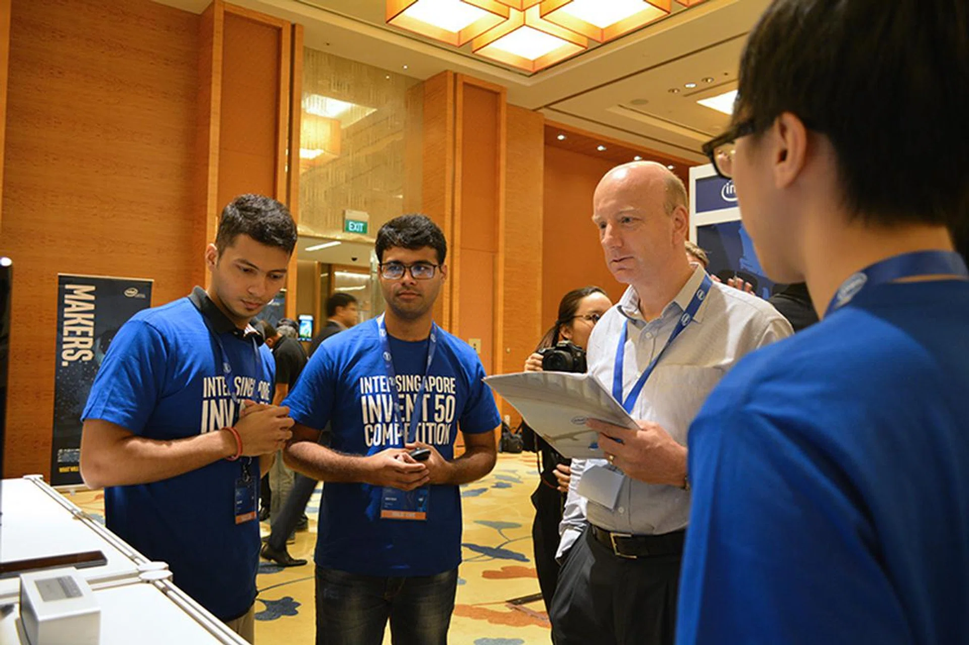 Mike Holt, VP of SSIA, seen here with team PlanChase, which proposed an app that can provide users with crowd density data and help them plan their trips better.