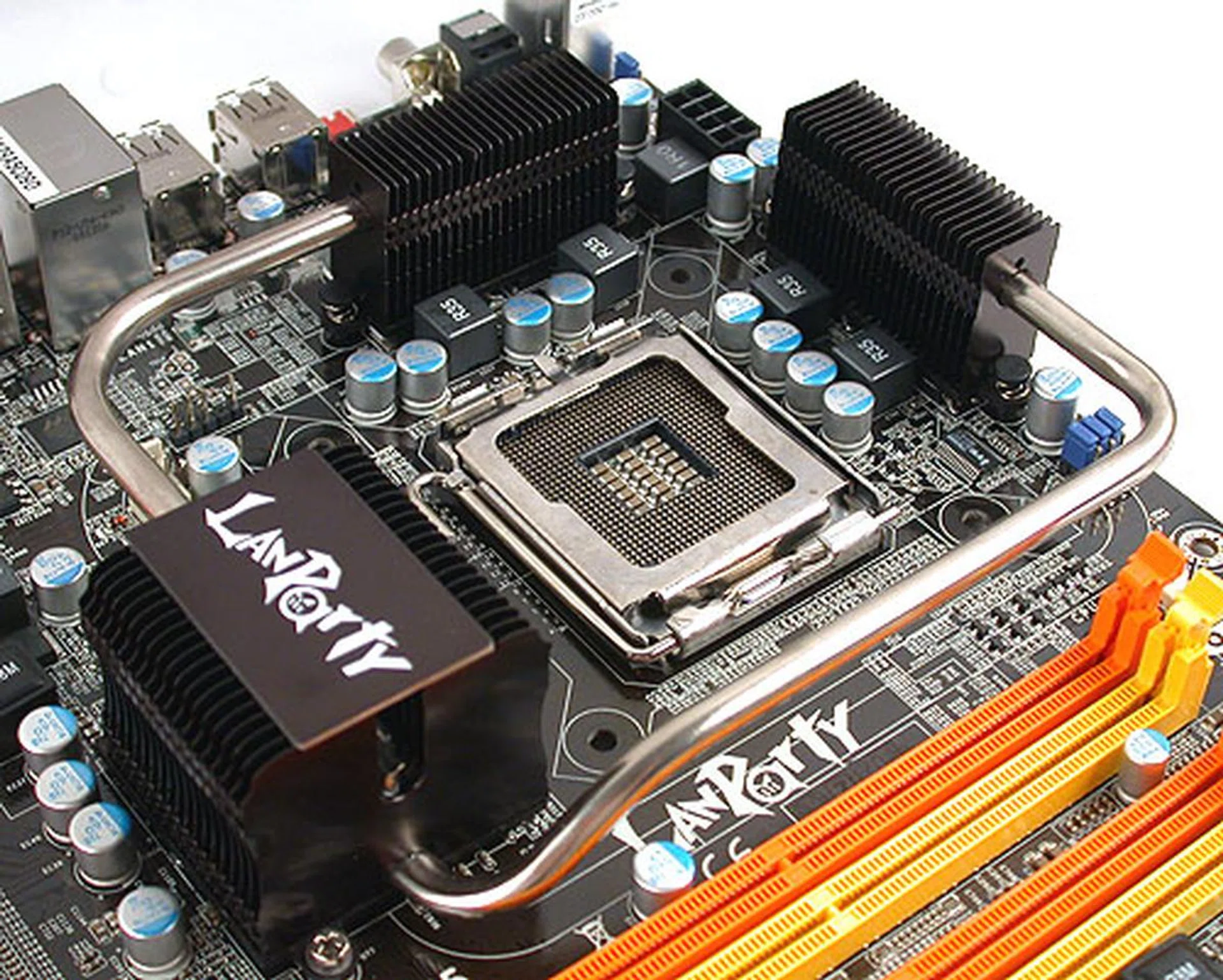 DFI uses a 4-phase digital PWM to regulate power to the processor and the MOSFETs are all buried under this black and silver, heat pipe based cooling system here. Fortunately, there is more than sufficient allowance for larger coolers at the CPU socket and as you can clearly see, DFI is another vendor who touts the virtues of solid capacitors (from Japan no less).