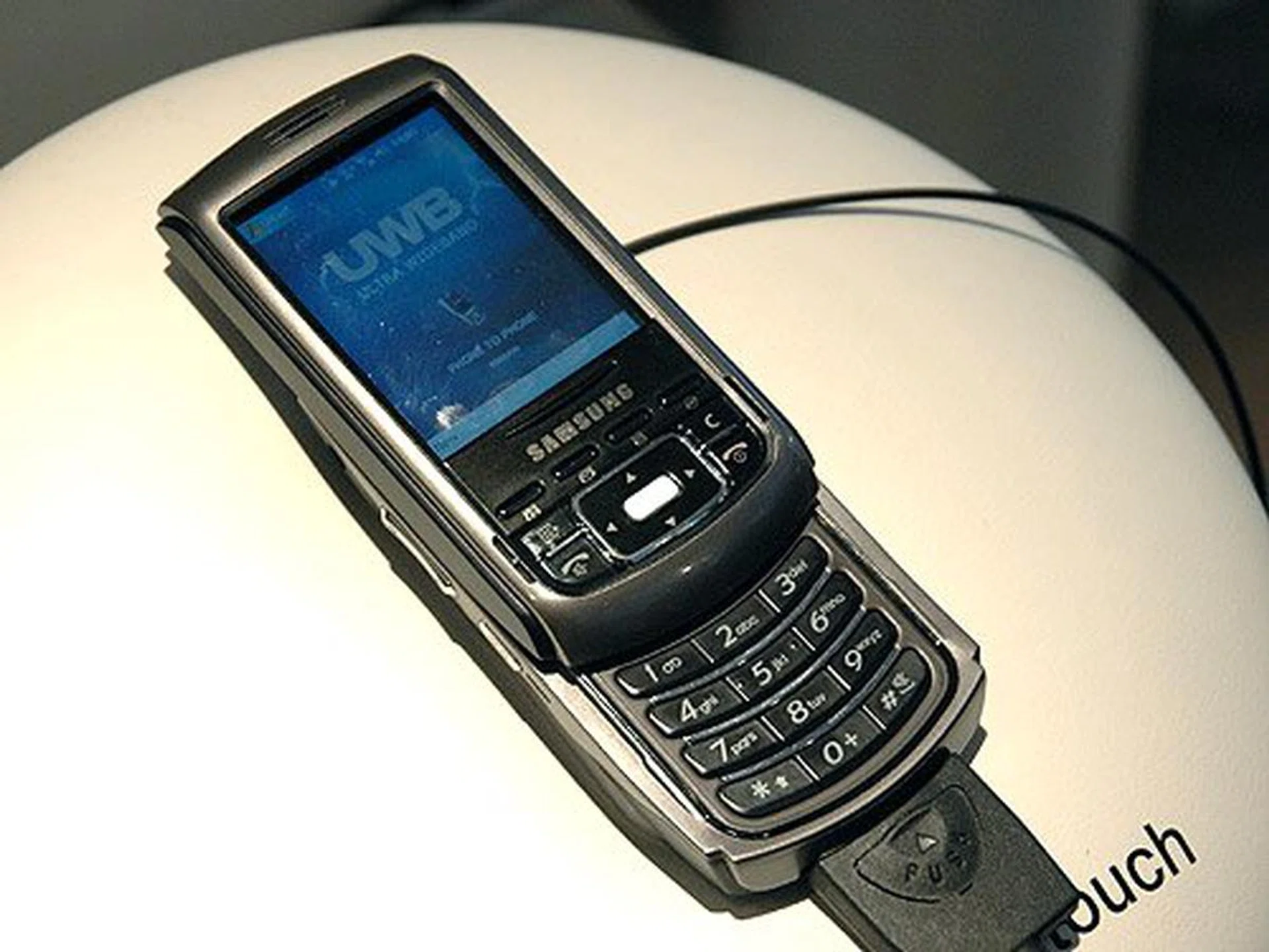 Samsung demonstrates UWB (Ultra Wide Band) technology with their new UWB phone. UWB allows short range and high-speed data transmission between devices similar to Bluetooth but at a much higher data rate.