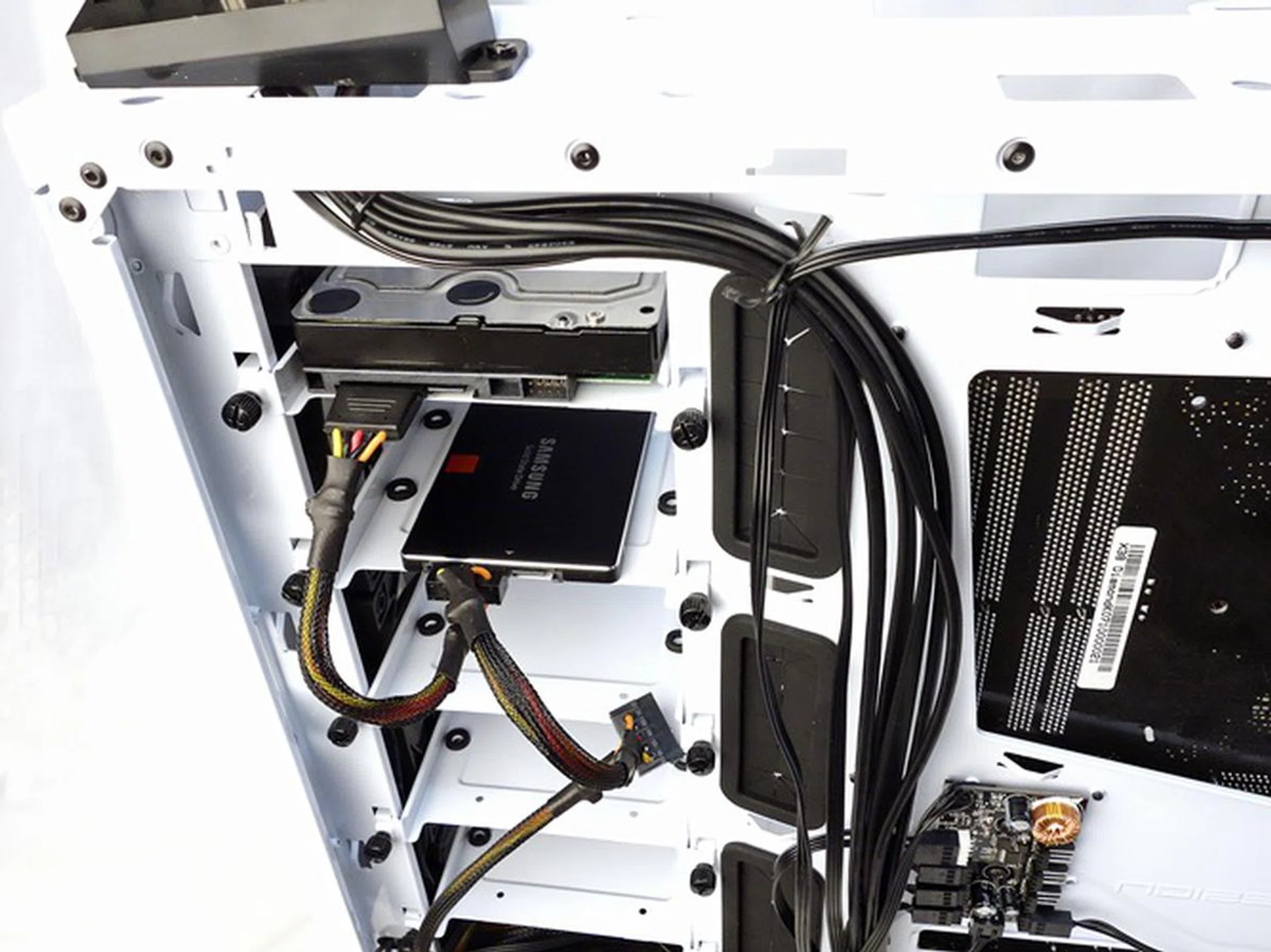 The drive mounting trays were secured to their places with a pair of thumbscrews.