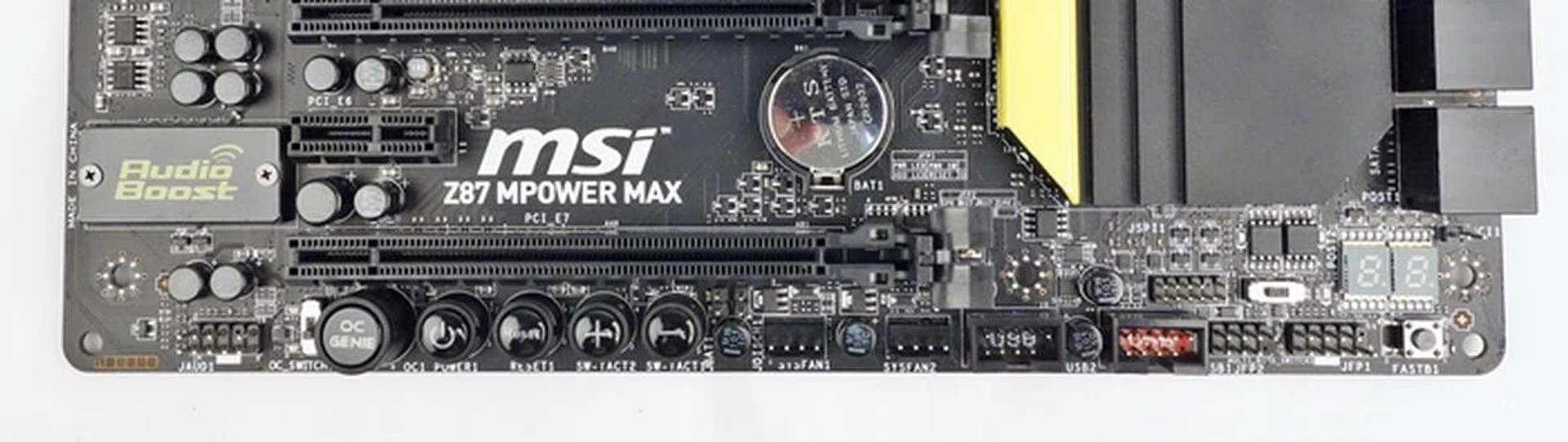 From the left edge of the board is the front panel audio header. The row of onboard buttons break the succession of the other headers that include a pair for system fans, followed by two USB 2.0 ones. The front panel headers are divided into two sections, with a Go2BIOS button at the end.