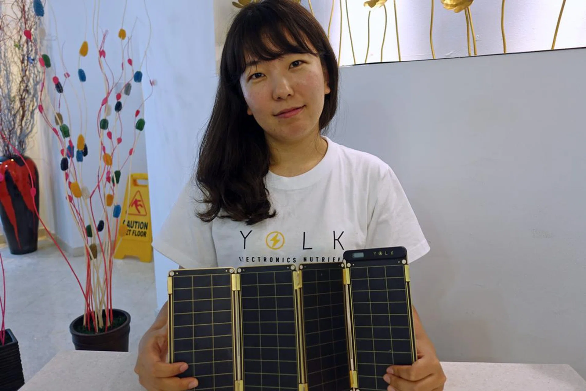 Sungun Chang, designer and CEO of her startup, Yolk, with the Solar Paper.