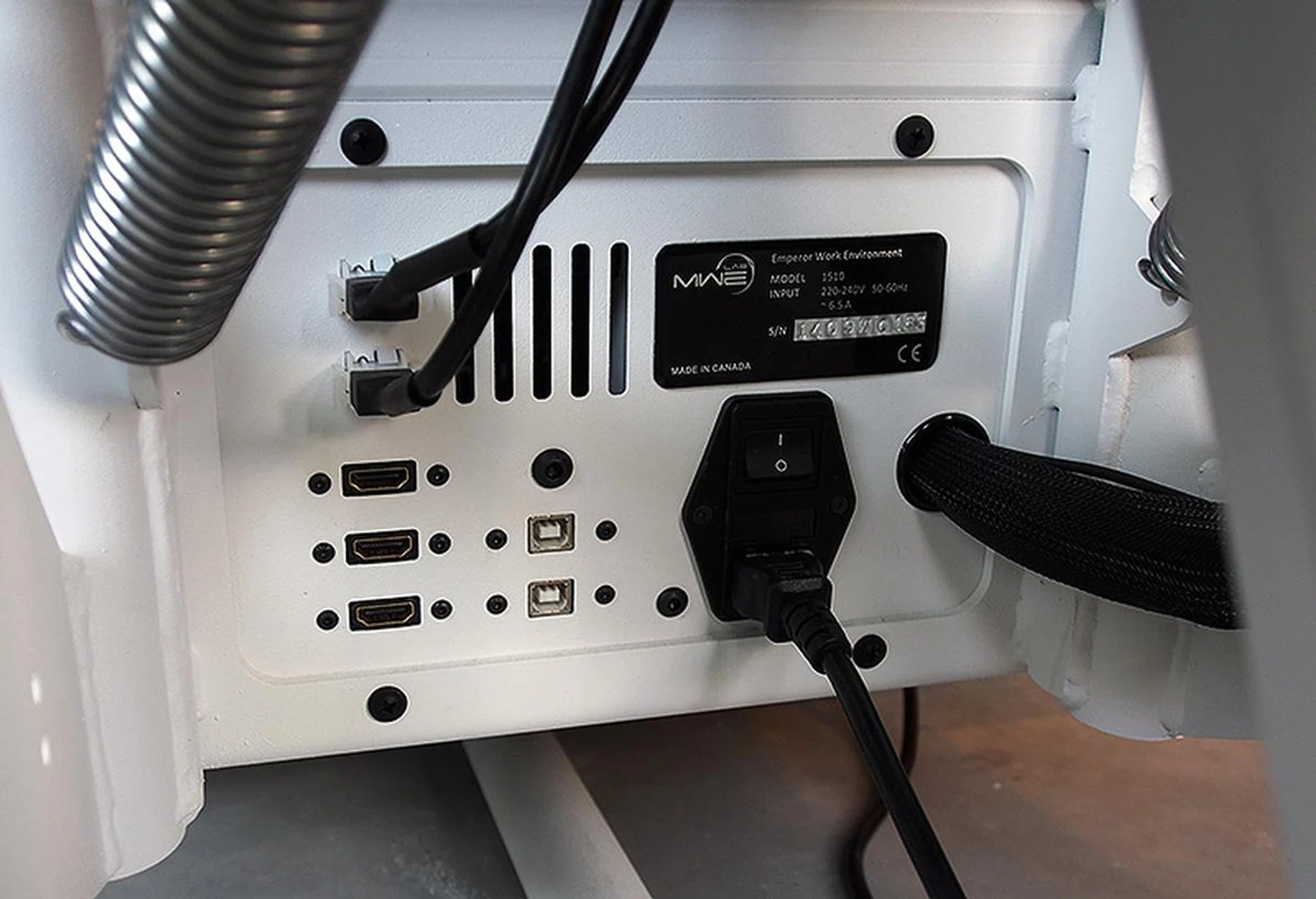 Inputs for the monitor and speaker systems are located behind and below the seat.
