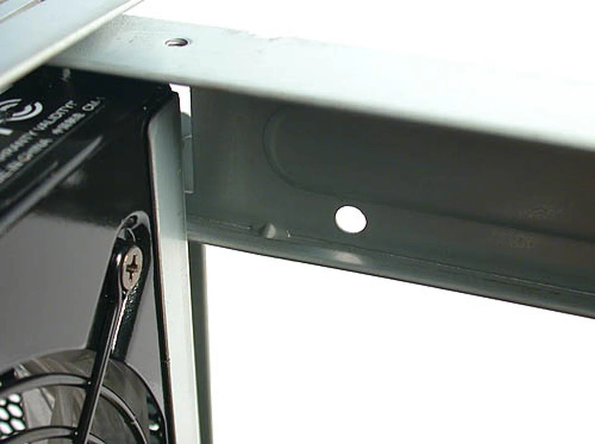 One of the holes intended by AOpen for you to route your nest of cables using the given cable ties. It's a good idea but lazy users may not bother.