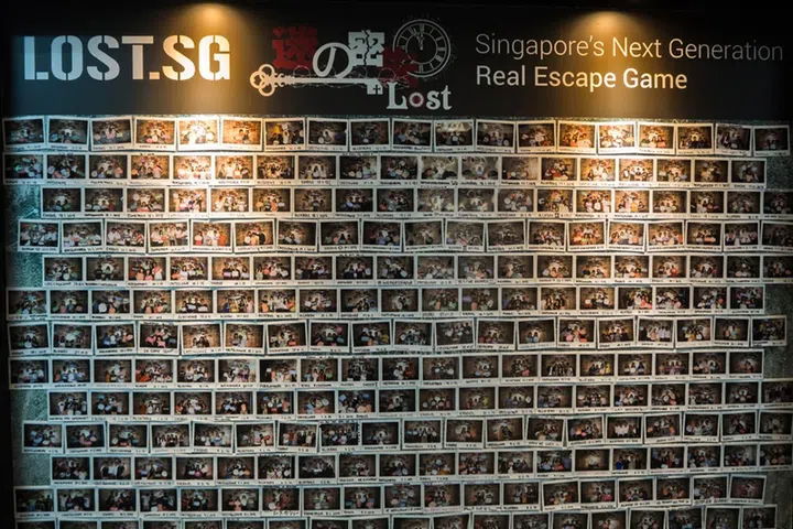 One of the many, many walls adorned with pictures of those who've attempted the rooms.