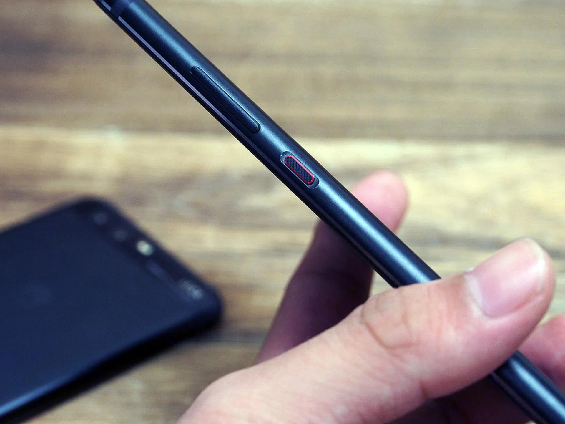 The tactile power button with a stylish red rim.