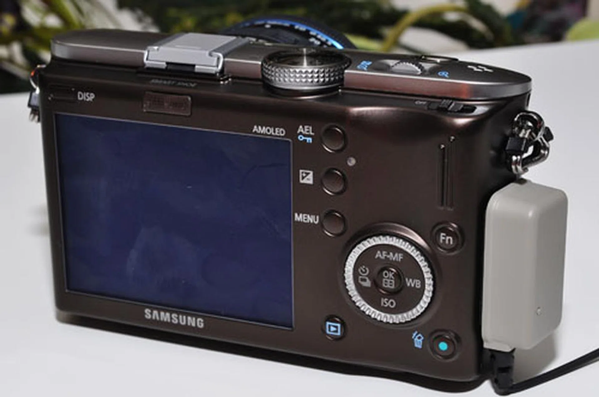 The i-Function lens ring works in tandem with the dial wheel on top and scroll wheel on the back to control the camera settings.