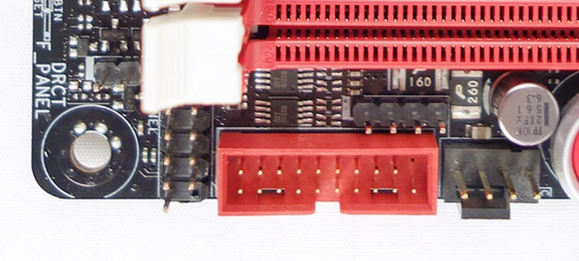 On the left of the red USB 3.0 connector, there is the front panel connector. At its top, there is the 4-pin speaker connector, and to its right, there is a chassis fan connector.