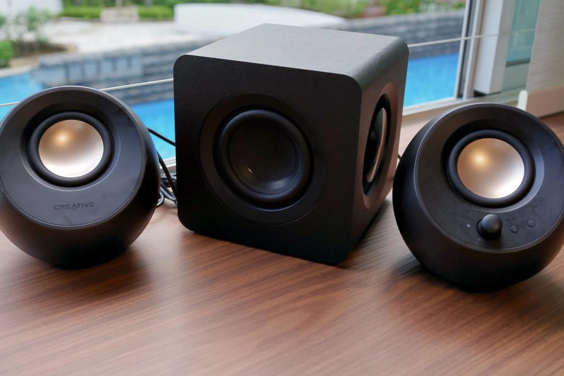 The Creative Pebble X Plus consists of two compact satellite speakers and a larger subwoofer.