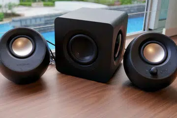 The Creative Pebble X Plus consists of two compact satellite speakers and a larger subwoofer.