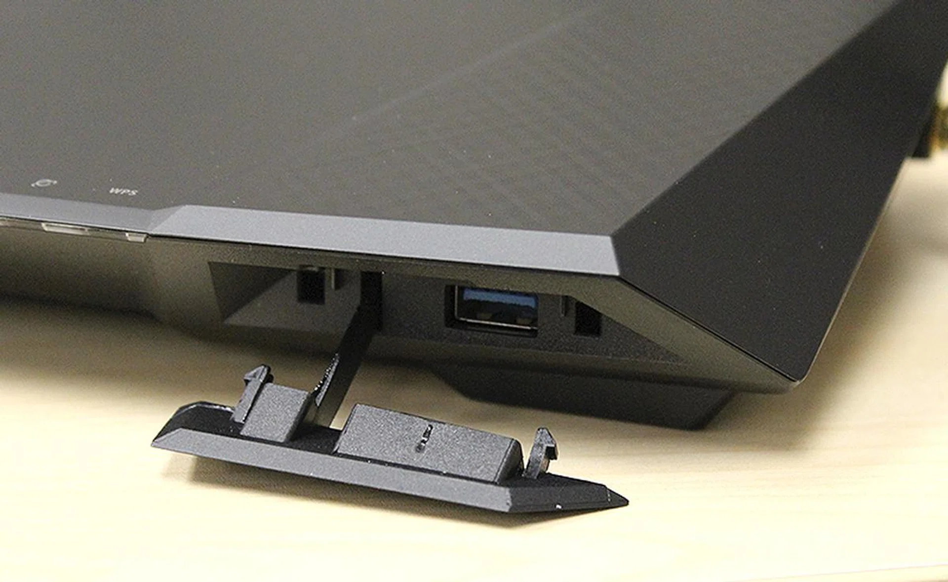 The USB 3.0 port is located in front behind this dust cover.