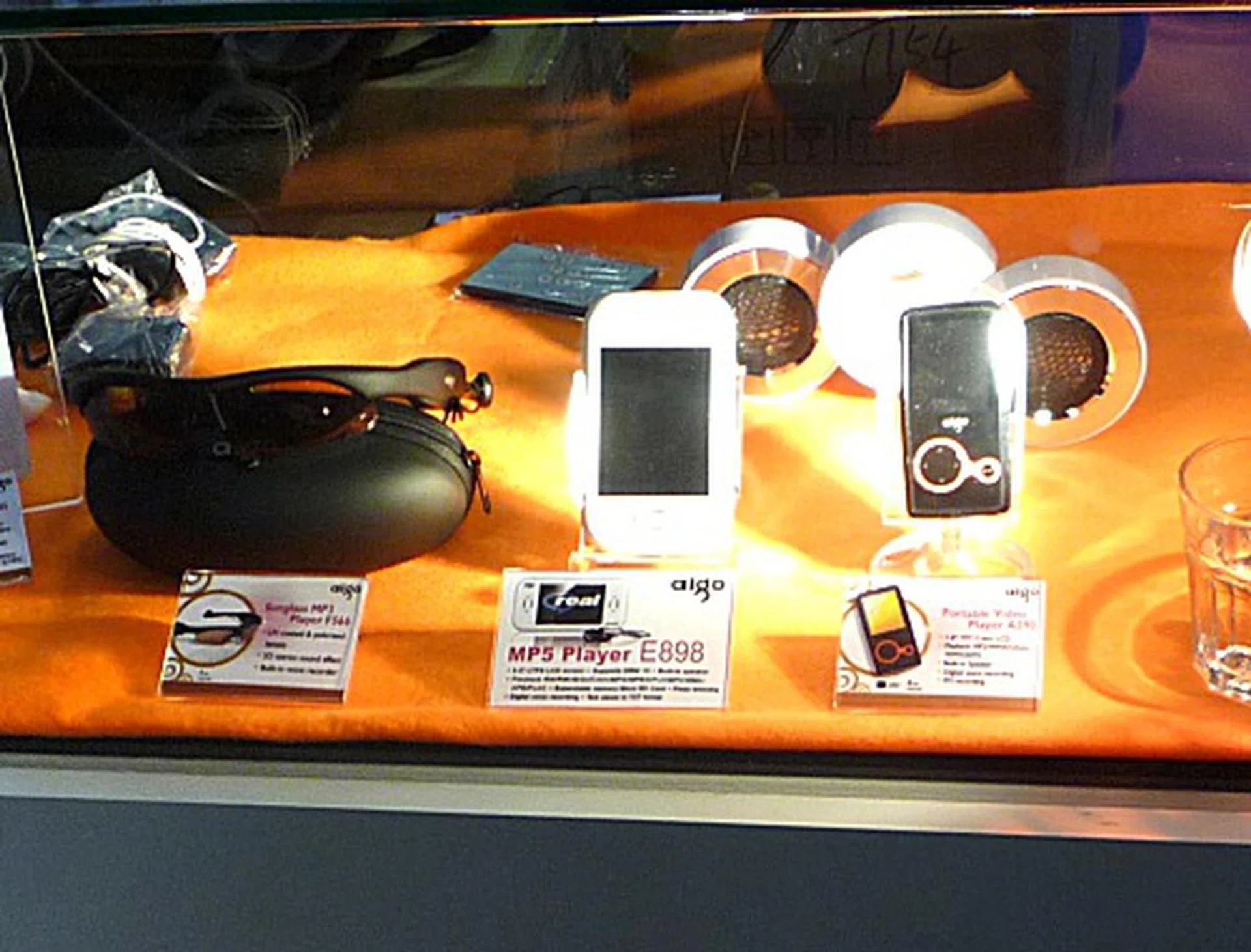  From left to right: Aigo's Sunglass MP3 F566 player for all your outdoor musical needs, the E898 4GB video and music player and lastly, the A390 which has a built in speaker.  