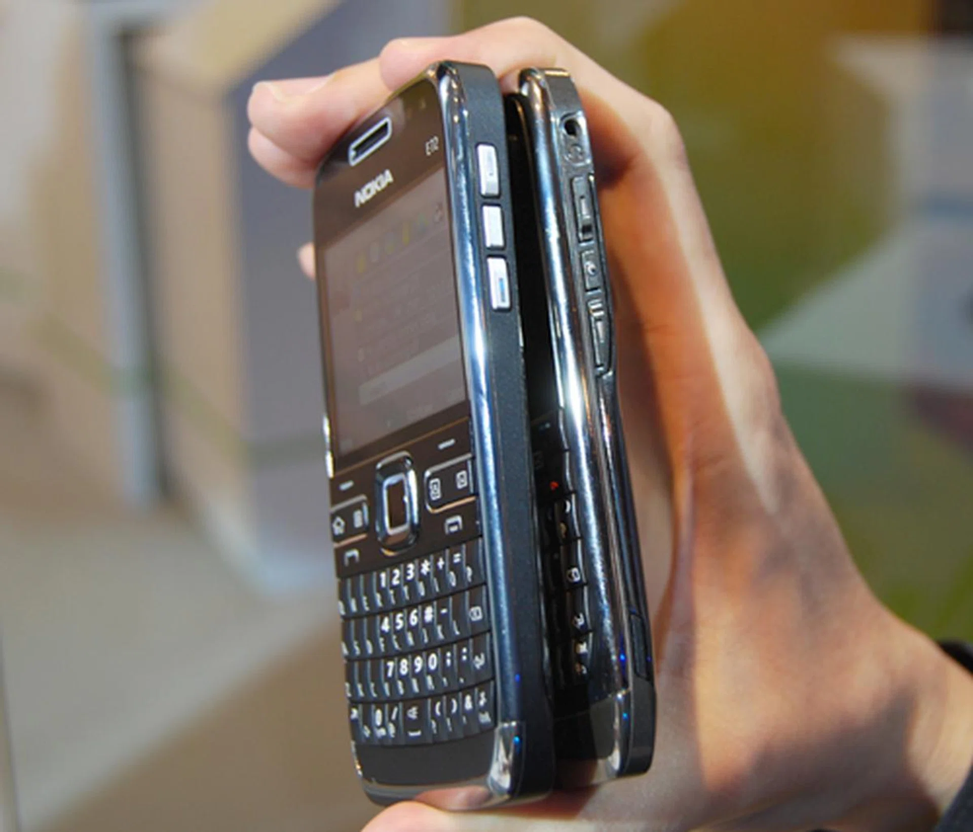  According to the dimensions, the E72 just a mm or so thicker than its predecessor, which isn't that obvious from the looks of it here. The device still retains the slim and easy to handle form factor that we loved on the E71.  