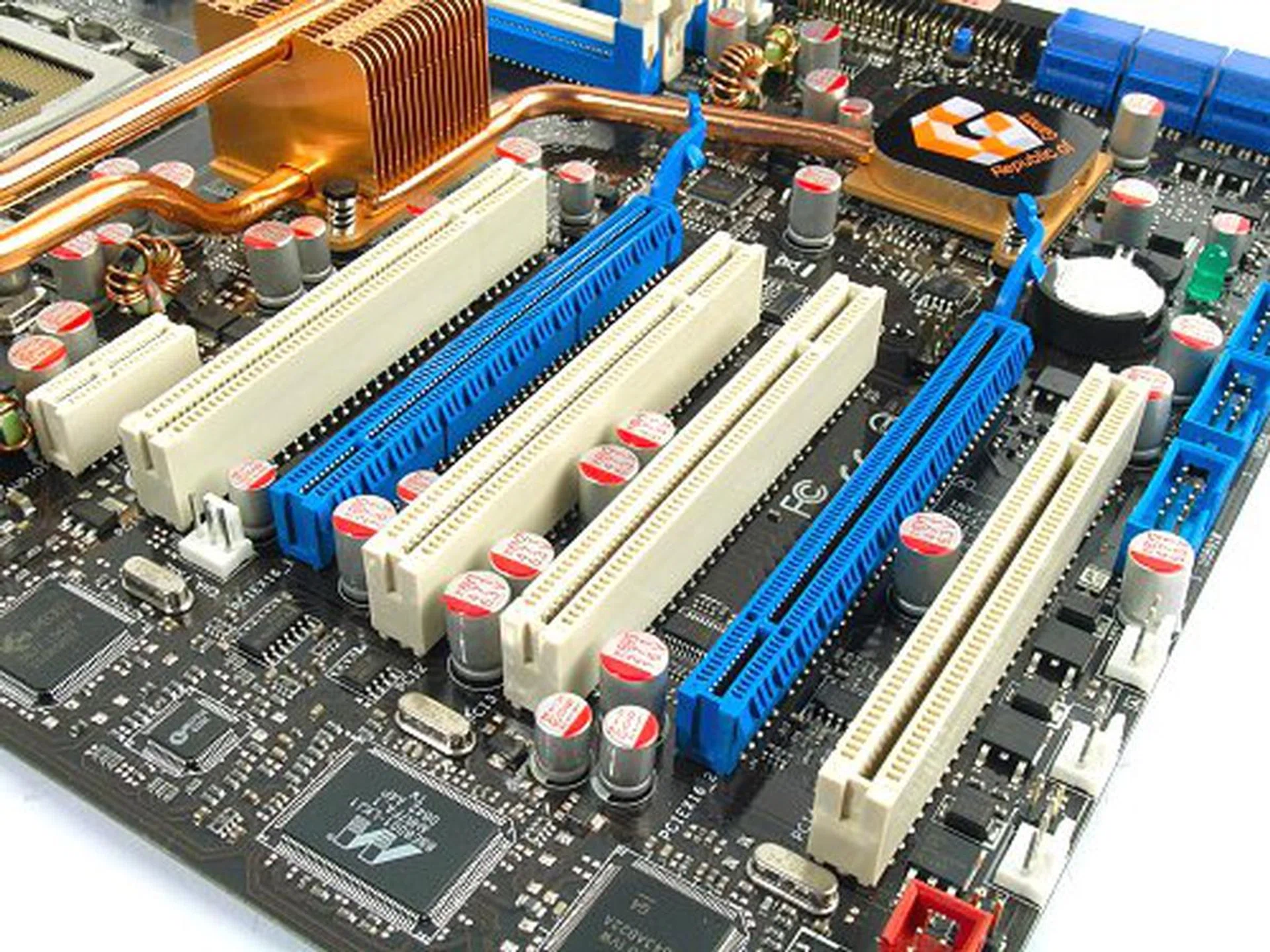 Full complement of PCI slots. Large graphics card will still be a problem, but the staggered design lets you have a few slots to use. Notice the solid capacitors and abundance of fan headers in this corner alone.