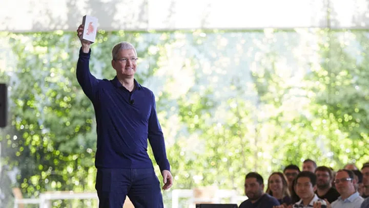 Tim Cook holding the billionth iPhone sold at an Apple employee meeting in Cupertino this morning.